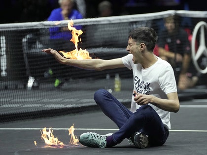 Protester Sets Arm On Fire In Wild Scene At Roger Federer's Last Tournament
